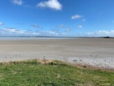 The lake was 'half empty.' The water was a long way from shore. The dry surface had a grey appearance.