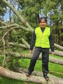 Fiona standing on fallen tree at river